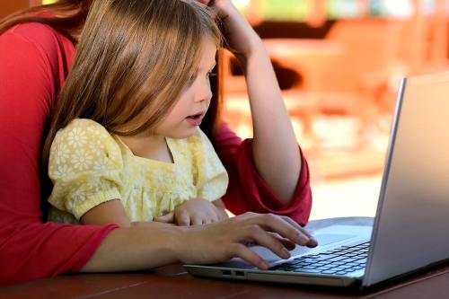 Adult and child using a laptop